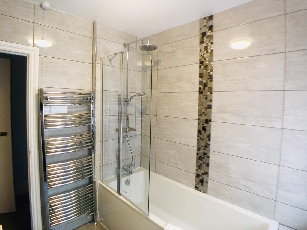 En-suite bathroom with bath and shower