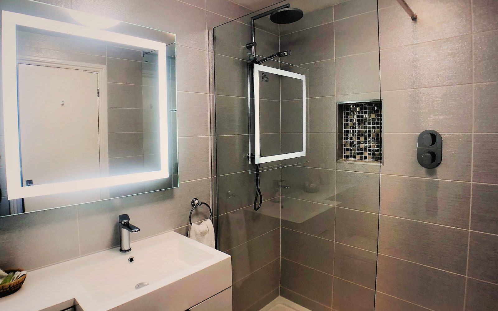 Walk-in rain shower with illuminated mirror