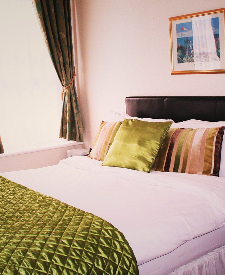 Bright double room with seaside artwork