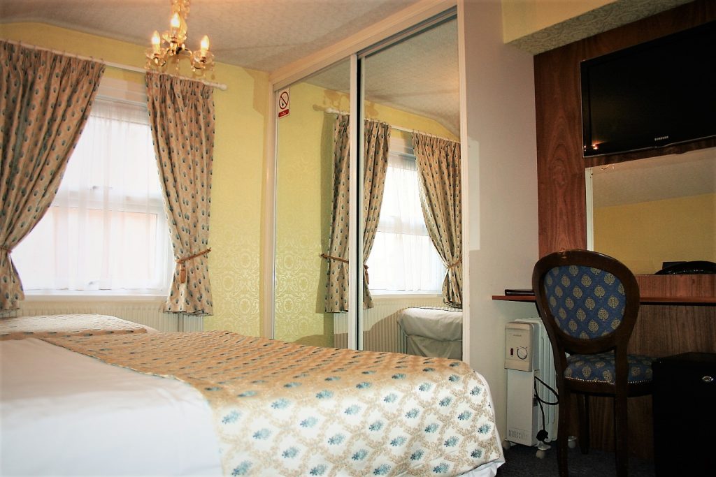 Double room with dressing table and wardrobe